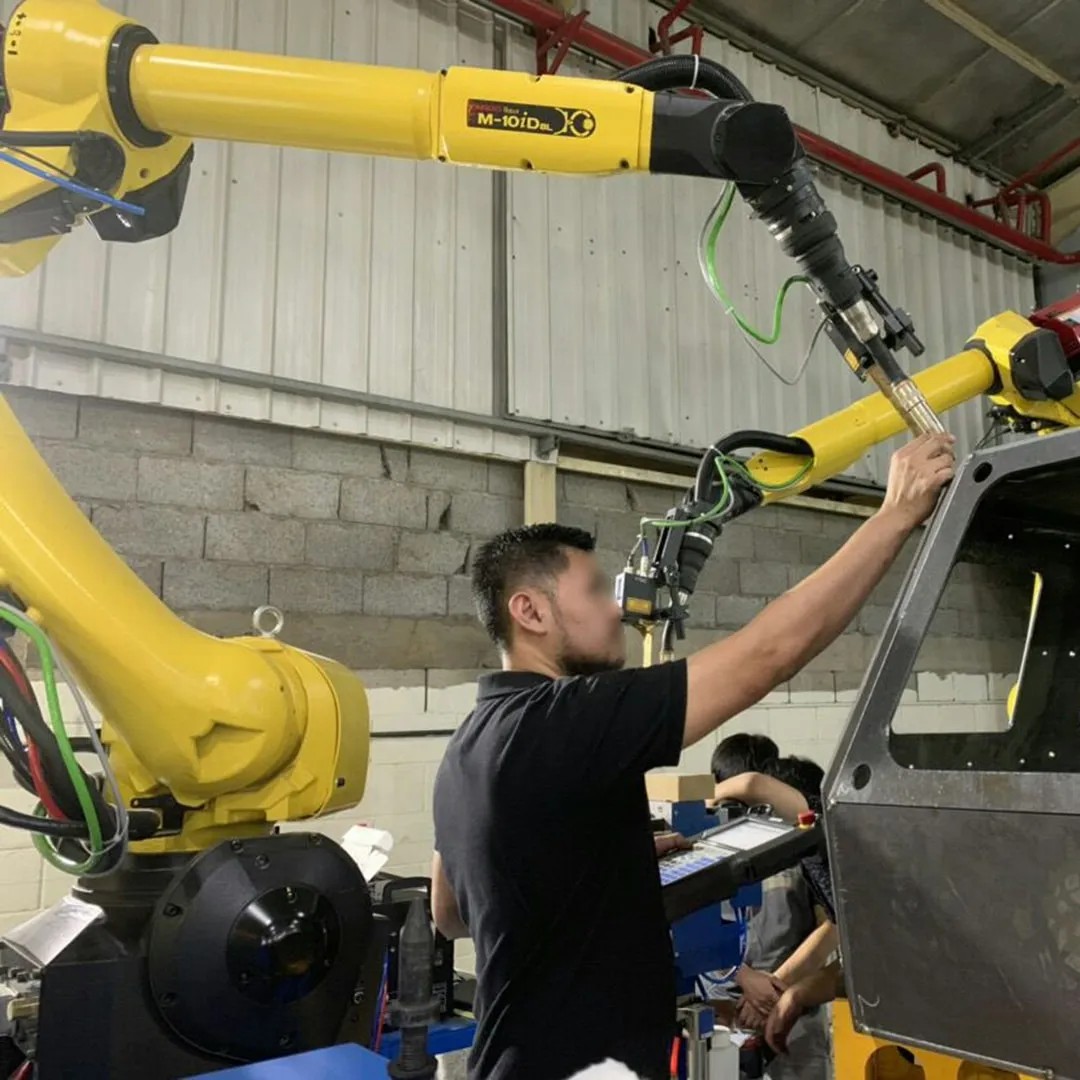 Robotic welding system applied to vehicle structure welding in a production environment